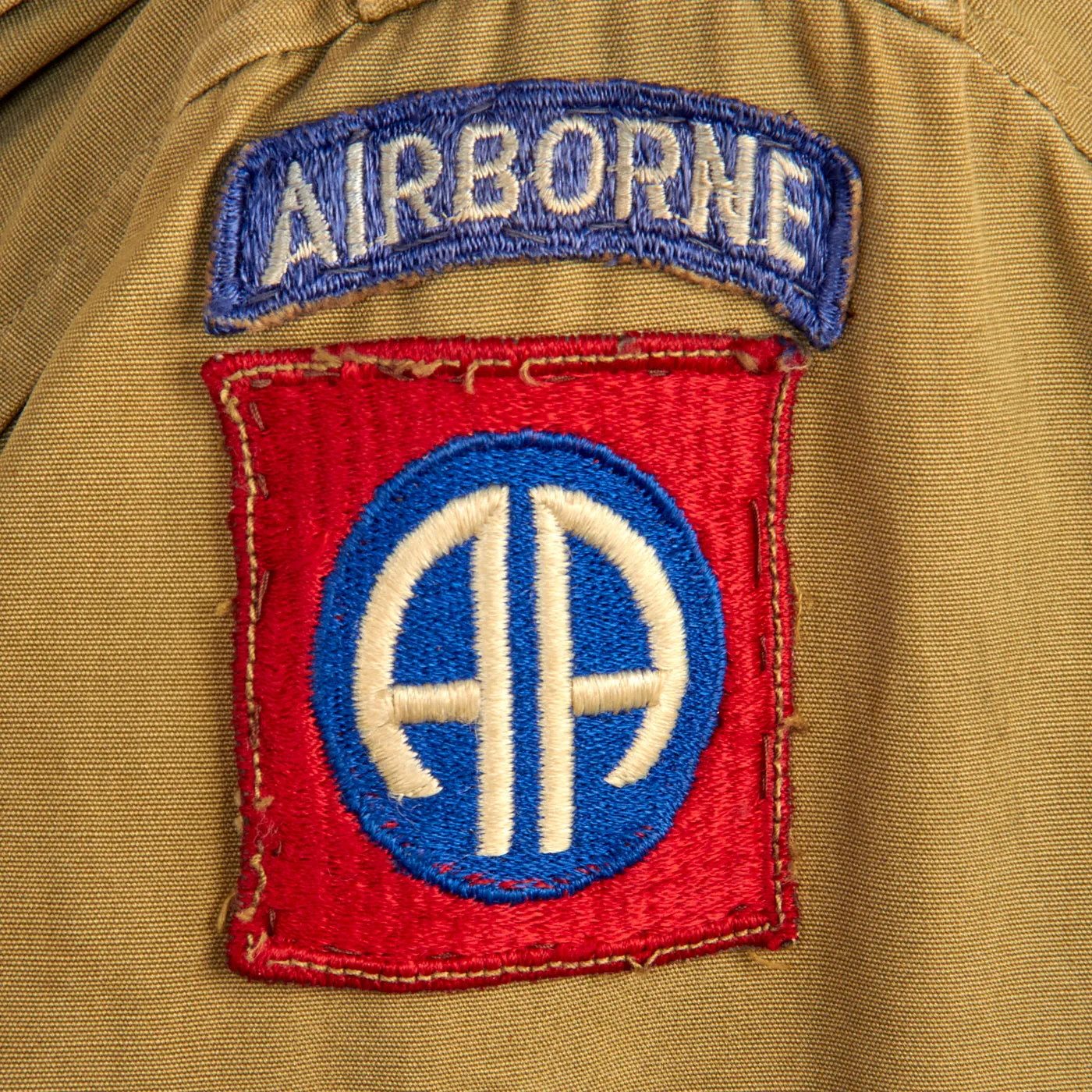 Original U.S. WWII Named 82nd Airborne Uniform Grouping Featuring Custom Camouflage Parachute Silk Lined Overseas Cap - With Documents