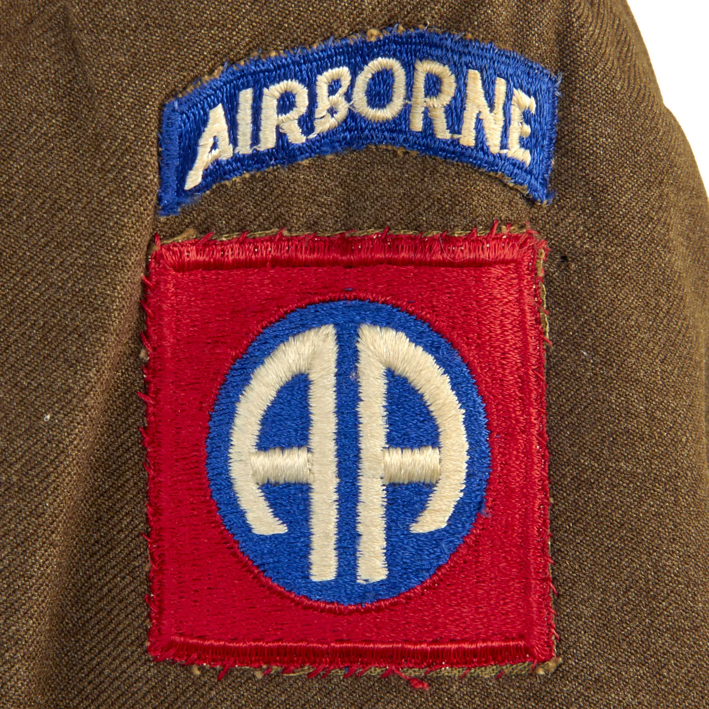 Original U.S. WWII Named 82nd Airborne Uniform Grouping Featuring Custom Camouflage Parachute Silk Lined Overseas Cap - With Documents